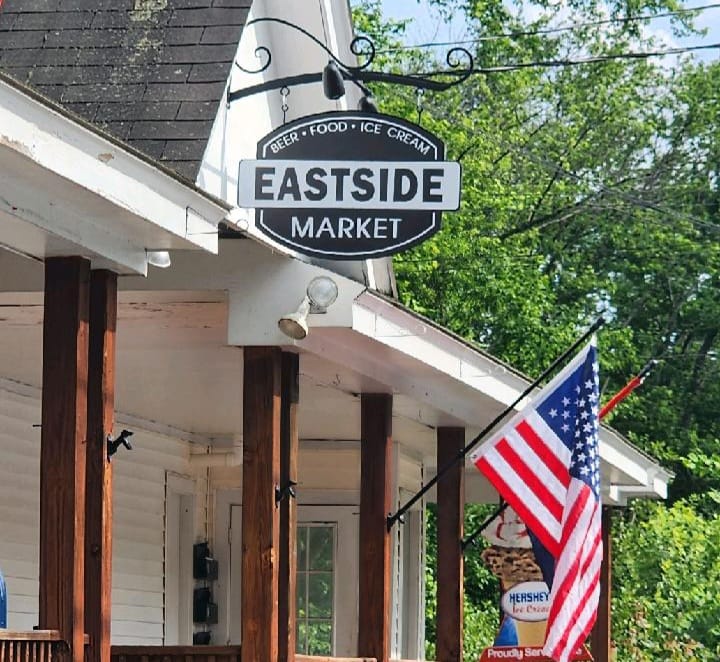 Picture of Market Entrance displaying the sign and an American Flag
